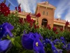 old main rises above purple and red flowers
